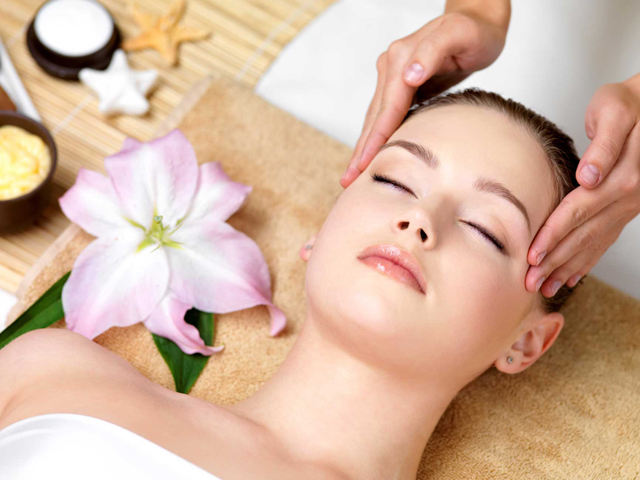 woman having spa massage of the head